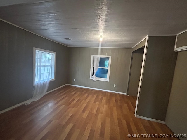 interior space featuring baseboards, visible vents, and wood finished floors