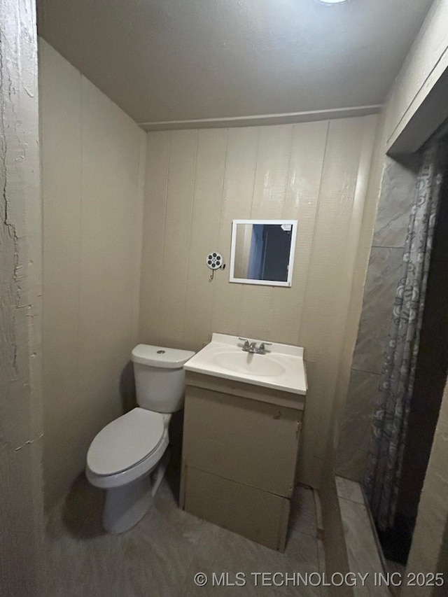 bathroom featuring toilet and vanity