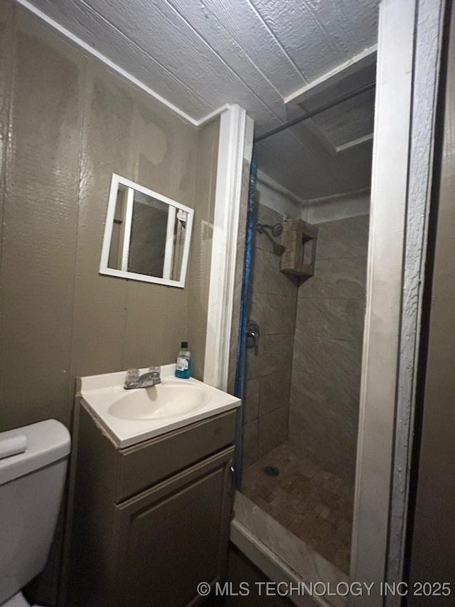 full bathroom featuring vanity, a shower stall, and toilet