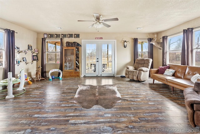 interior space with wood-type flooring, a ceiling fan, a textured ceiling, and french doors