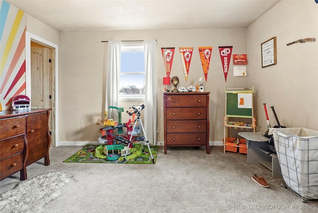 recreation room with carpet floors and baseboards