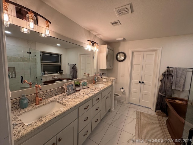 bathroom featuring a stall shower, visible vents, toilet, marble finish floor, and a sink