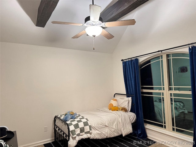 bedroom with a ceiling fan, vaulted ceiling, and wood finished floors