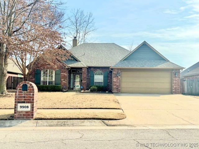 view of front of property featuring a chimney, fence, concrete driveway, and brick siding