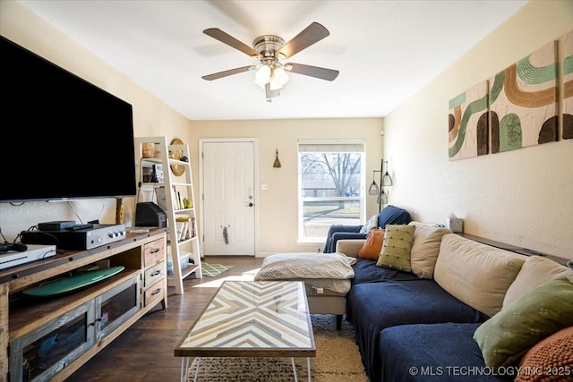 living area with dark wood-style floors and ceiling fan