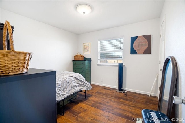 bedroom featuring baseboards and wood finished floors