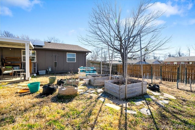 view of yard featuring a fenced backyard and a garden