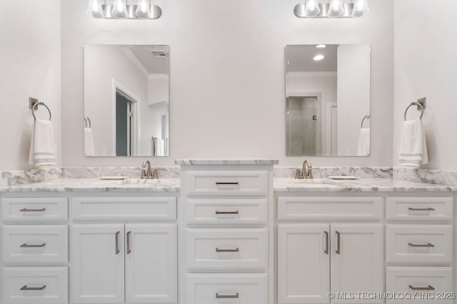 bathroom with visible vents, crown molding, and vanity