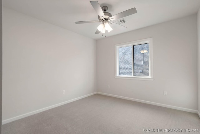 unfurnished room with light carpet, ceiling fan, visible vents, and baseboards