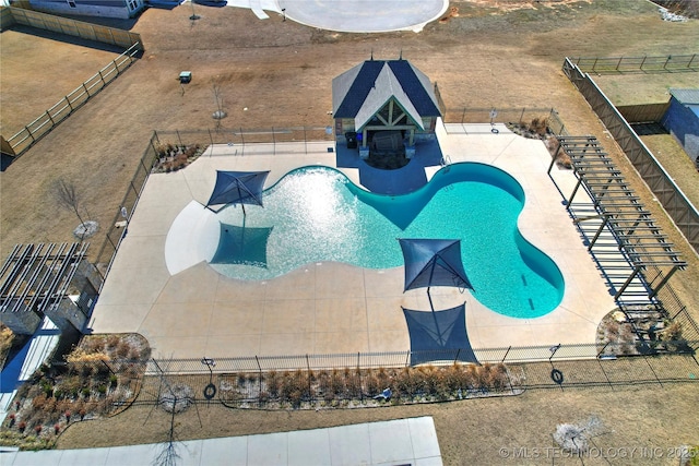 community pool featuring a patio and fence