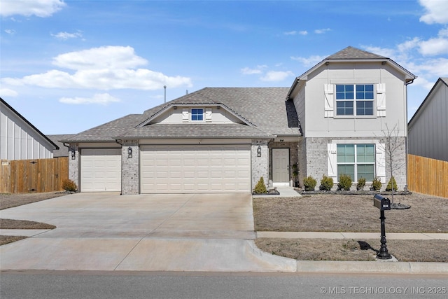 traditional-style home with a garage, concrete driveway, brick siding, and fence