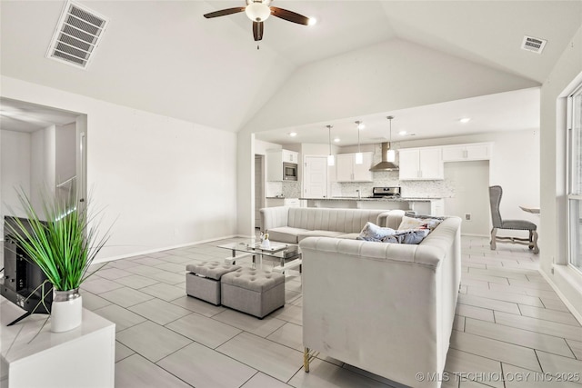 living room with ceiling fan, high vaulted ceiling, light tile patterned floors, and visible vents