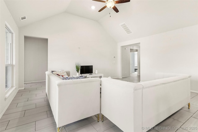 living room featuring vaulted ceiling, visible vents, and a ceiling fan