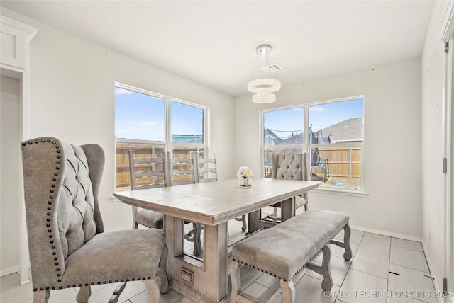 dining room featuring an inviting chandelier, baseboards, and visible vents