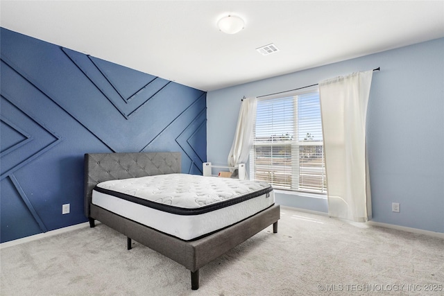 bedroom featuring carpet floors, visible vents, and baseboards