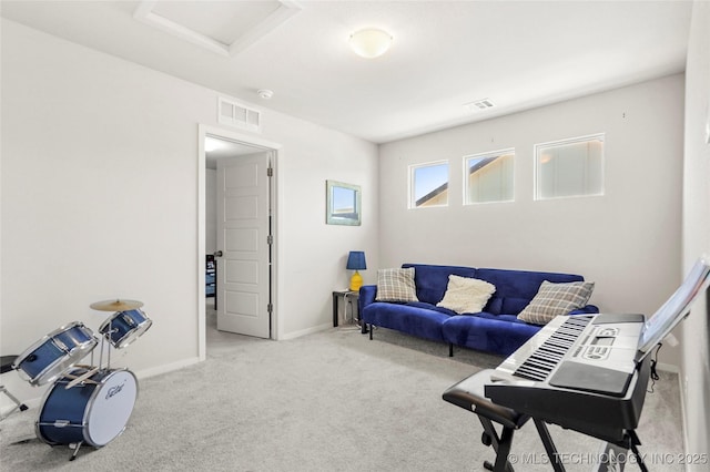 living area featuring baseboards, carpet floors, visible vents, and attic access