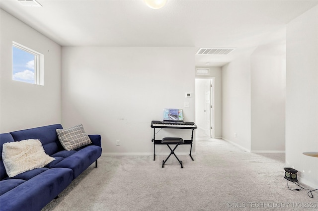 carpeted living area featuring baseboards and visible vents