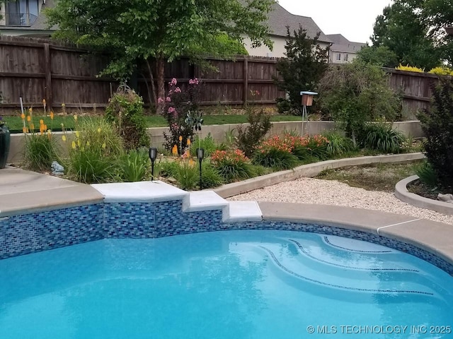 view of swimming pool featuring a fenced backyard and a fenced in pool