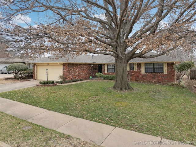 ranch-style house with a front lawn, concrete driveway, brick siding, and an attached garage