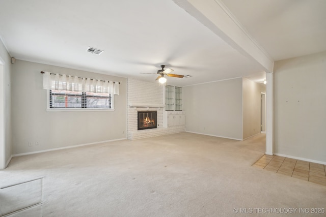 unfurnished living room featuring visible vents, a ceiling fan, a brick fireplace, carpet flooring, and baseboards