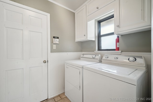 laundry room featuring cabinet space, ornamental molding, and separate washer and dryer