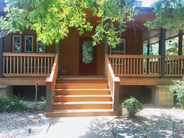 doorway to property with a porch