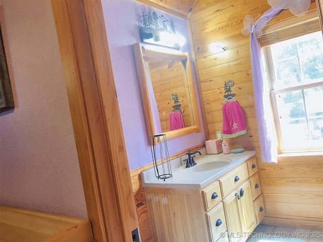 bathroom with wood walls and vanity