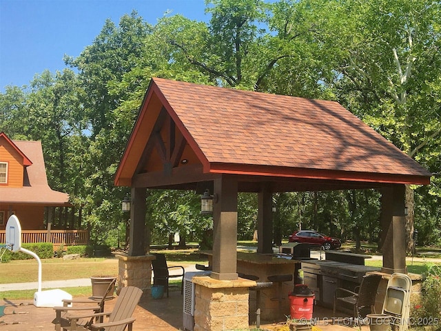 view of community featuring a patio area, outdoor dry bar, and a gazebo