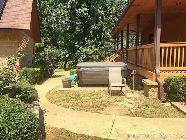 exterior space with a hot tub