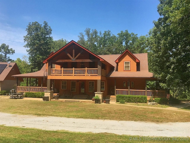 view of front of property with a front lawn, a porch, and a balcony