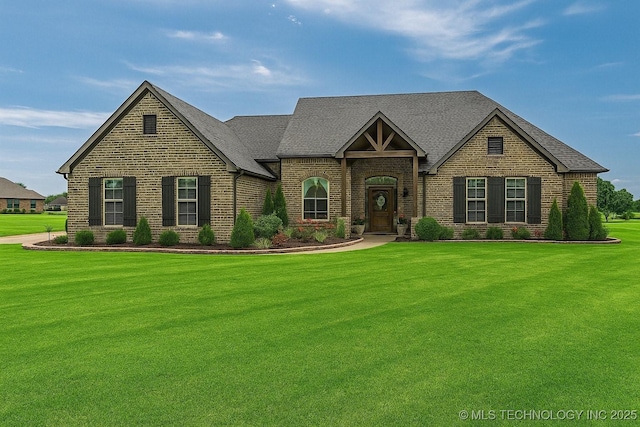 17 Tabernacle Dr, Calera, OK 74730 - view of front of home with roof with shingles, brick siding, and a front lawn