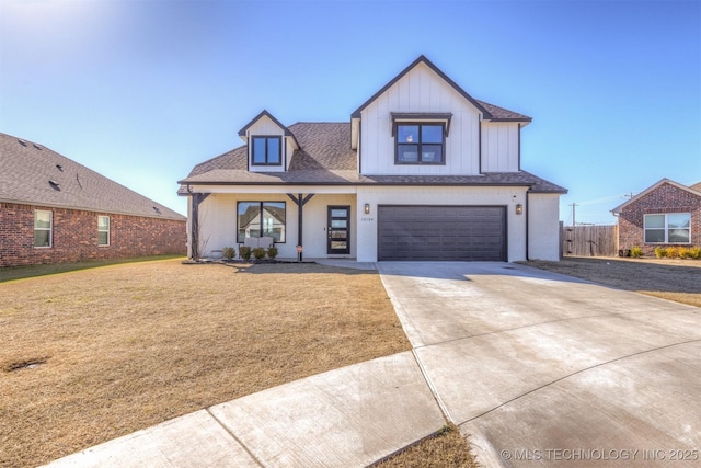 modern farmhouse style home featuring a garage, fence, driveway, roof with shingles, and a front lawn