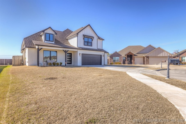 view of front of property featuring a shingled roof, an attached garage, a front yard, fence, and driveway