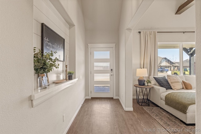 foyer with wood finished floors and baseboards