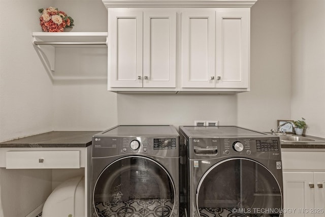 laundry room with a sink, washing machine and dryer, and cabinet space