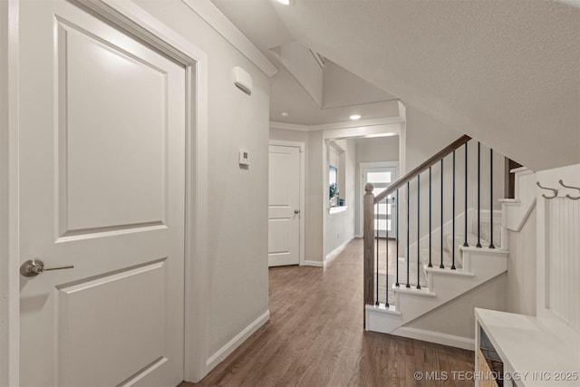 interior space with stairway, baseboards, wood finished floors, and recessed lighting