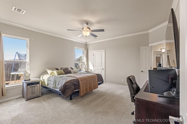 bedroom featuring light carpet, a ceiling fan, baseboards, visible vents, and crown molding