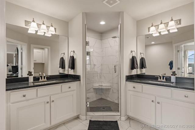 bathroom with marble finish floor, visible vents, and a sink