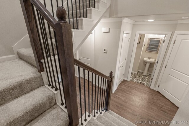 stairs with baseboards and wood finished floors