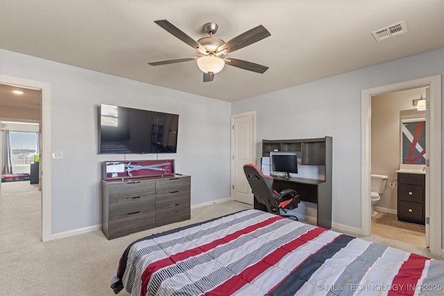 carpeted bedroom featuring a ceiling fan, connected bathroom, visible vents, and baseboards