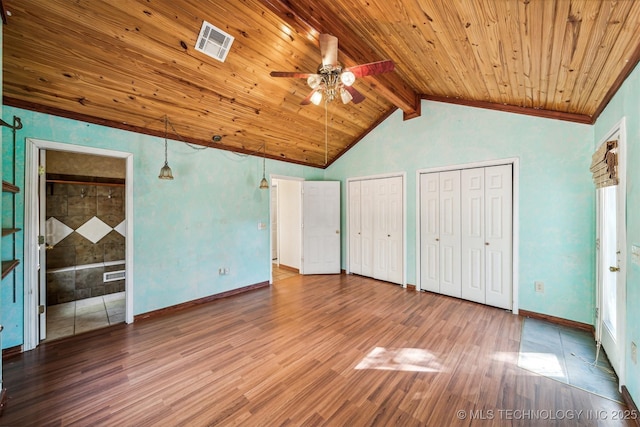 unfurnished bedroom featuring vaulted ceiling with beams, wood finished floors, wood ceiling, visible vents, and multiple closets