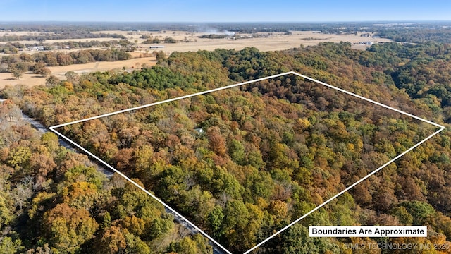 aerial view featuring a wooded view