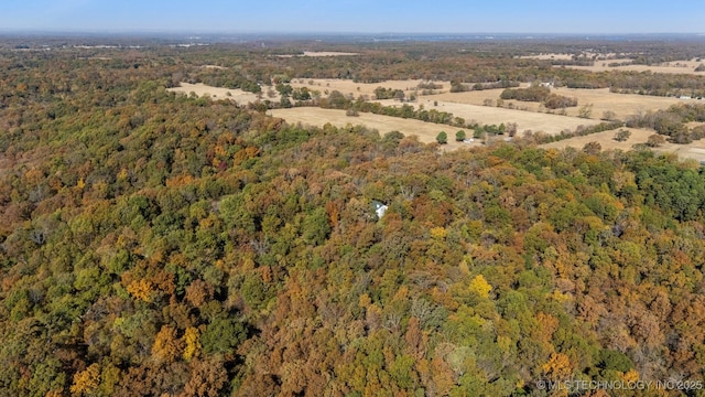 drone / aerial view featuring a wooded view