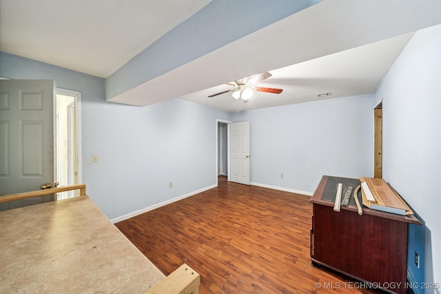 unfurnished room with ceiling fan, wood finished floors, visible vents, baseboards, and vaulted ceiling