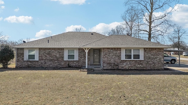 ranch-style house with brick siding, a shingled roof, and a front yard