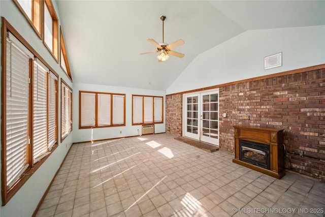 unfurnished sunroom featuring a glass covered fireplace, lofted ceiling, ceiling fan, an AC wall unit, and french doors