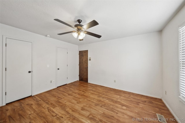 unfurnished bedroom featuring light wood-style floors and ceiling fan