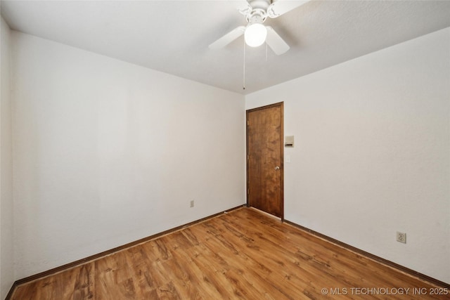 spare room featuring ceiling fan and light wood-style flooring