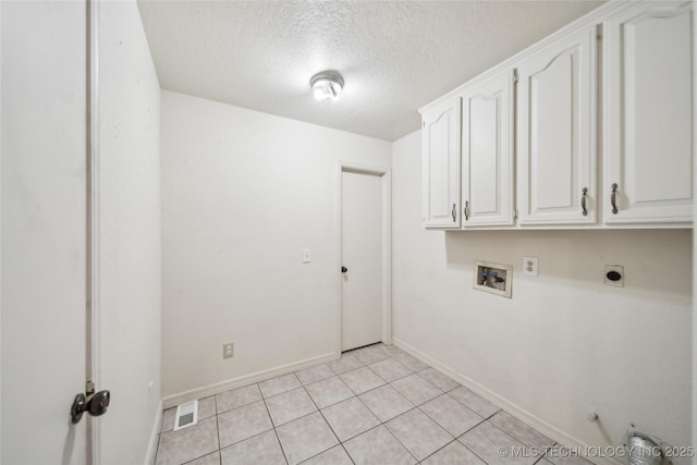 washroom featuring a textured ceiling, hookup for a washing machine, hookup for an electric dryer, visible vents, and cabinet space