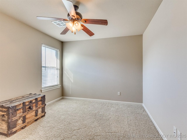 empty room featuring a ceiling fan, baseboards, and carpet flooring